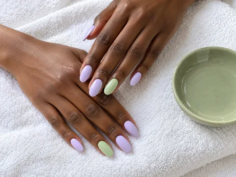 Soft lavender nails with a matcha green accent beside a green ceramic dish